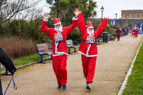 Runners undeterred by the weather start the Santa Fun Run at Southsea Castle