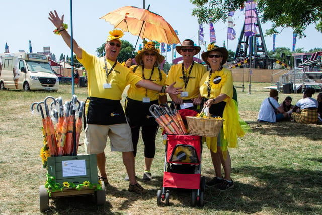 The Isle Of Wight Festival in Seaclose Park 2022. Pictured is: (l-r) Carl and Karen Bridgeman and Kevin and Julia Chandler raising money selling sunflower merchandise for the Mountbatten Hospice in Newport. Picture: Emma Terracciano