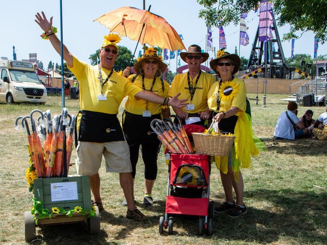 The Isle Of Wight Festival in Seaclose Park 2022. Pictured is: (l-r) Carl and Karen Bridgeman and Kevin and Julia Chandler raising money selling sunflower merchandise for the Mountbatten Hospice in Newport. Picture: Emma Terracciano