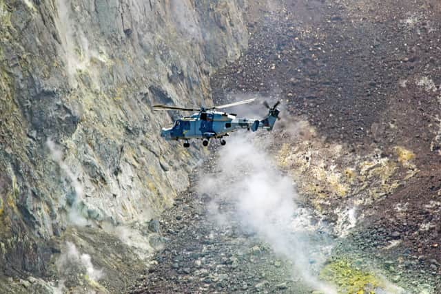 A Royal Navy Wildcat helicopter flying over the hot volcano on the island of Montserrat, Caribbean.