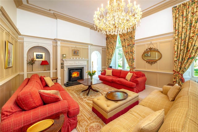 Here you can see the drawing room, boasting an impressive chandelier. The drawing room has amazing wood panelling throughout and an "intriguing archway" through to the garden room according to the description