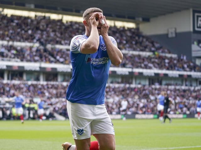 Goalscorer Colby Bishop jokes with the travelling Pompey fans after he scored his 20th League One goal of the season.