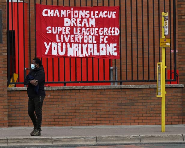 Banners critical of the European Super League project  hang from the railings of Anfield stadium, home of English Premier League football club Liverpool on April 21, 2021. Photo by Paul Ellis / AFP via Getty Images