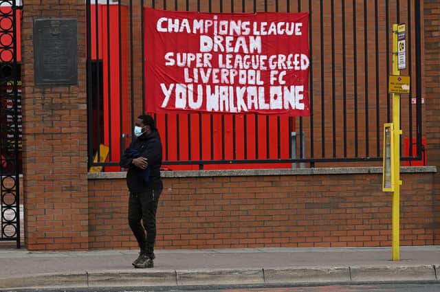 Banners critical of the European Super League project  hang from the railings of Anfield stadium, home of English Premier League football club Liverpool on April 21, 2021. Photo by Paul Ellis / AFP via Getty Images