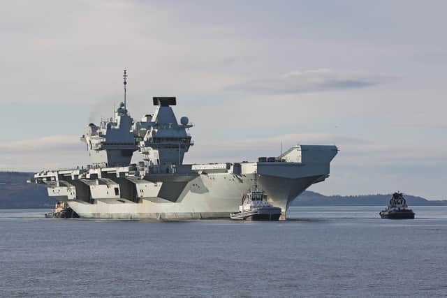 HMS Queen Elizabeth will spearhead the carrier strike group when it deploys in May. Here she is pictured during her latest trip to Scotland. Photo: PO JJ Massey