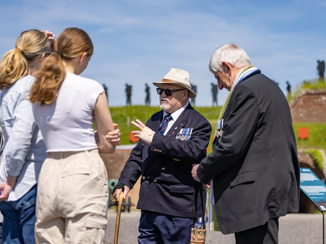 Veterans Alan Day and Ian Mathews speak with members of the public who attended the event at the Royal Armouries.