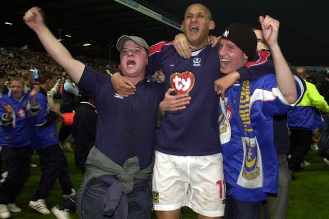 Nigel Quashie celebrates with Pompey fans after sealing promotion to the Premier League in April 2003. Picture: Jonathan Brady