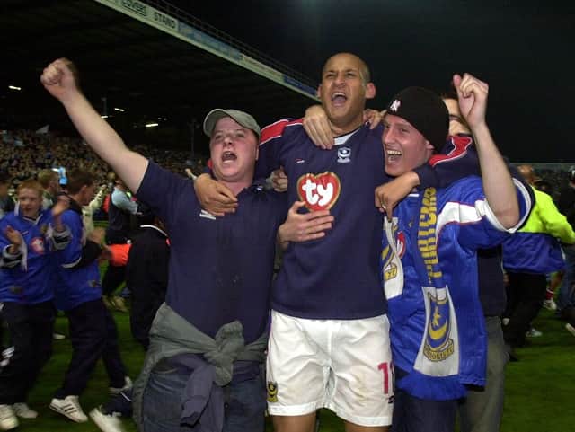 Nigel Quashie celebrates with Pompey fans after sealing promotion to the Premier League in April 2003. Picture: Jonathan Brady