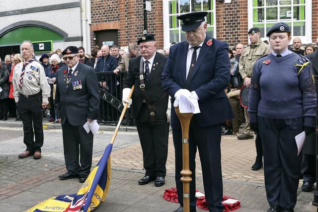 Standard bearers pay their respects during the two minute silence
Photo: Barry Zee