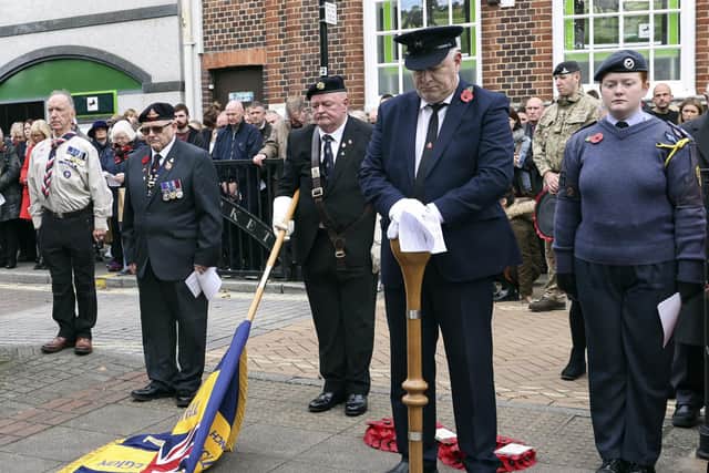 Standard bearers pay their respects during the two minute silence 

Photo: Barry Zee