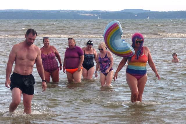 The team of volunteers complete their epic swim of one kilometre in the Solent, in aid of The Rainbow Centre.
