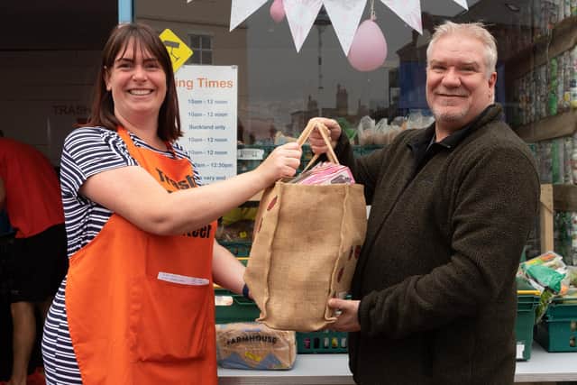 Volunteer Kay Coshela and customer Martin Jones.
Picture: Keith Woodland (200621-12)