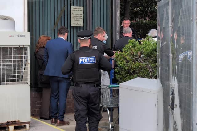 Police at the scene where a dead body was found in Wharf Road on Friday