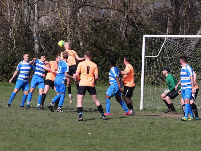 Action from the Buster Gordon Memorial Cup tie between AC Copnor (blue and white kit) and Seagull (orange and black kit). Picture: Sam Stephenson