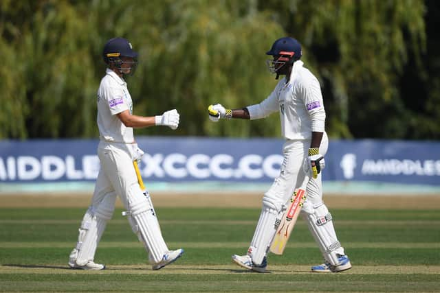 Joe Weatherley and Keith Barker of Hampshire about to touch gloves during their match-winning partnership against Middlesex at Radlett. Photo by Alex Davidson/Getty Images.