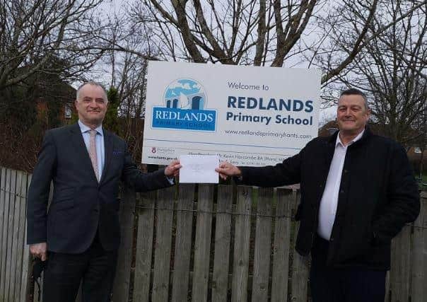 Redlands Primary School headteacher Kevin Harcombe (left) receives a cheque for £750 from Protec Technical Ltd managing director Martin Smyth