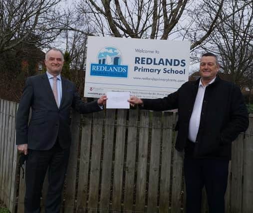Redlands Primary School headteacher Kevin Harcombe (left) receives a cheque for £750 from Protec Technical Ltd managing director Martin Smyth