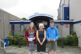 Headteacher Julie Summerfield with two students receiving their GCSE results