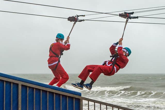 FLYING HIGH: HWB Chartered Accountants’ Richard Knight, left, and Harry Sherwood during the Santa Slide