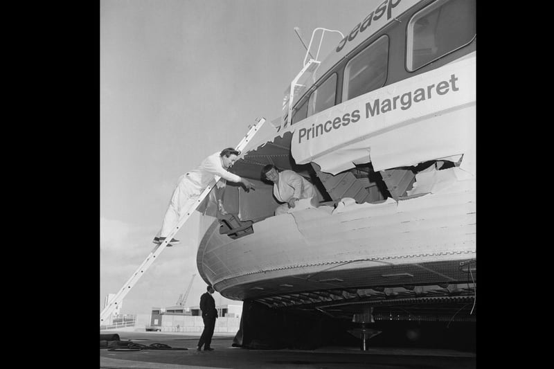 Two workers check Hovercraft SRN4 damage in starboard bow caused by vigorous waves, UK, 23rd September 1968. (Photo by Kent Photos/Daily Express/Getty Images)
