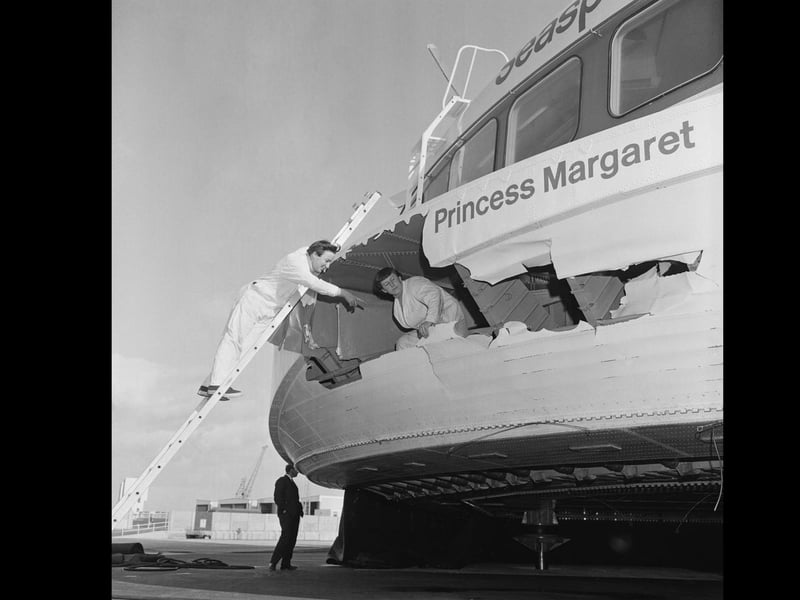 Two workers check Hovercraft SRN4 damage in starboard bow caused by vigorous waves, UK, 23rd September 1968. (Photo by Kent Photos/Daily Express/Getty Images)