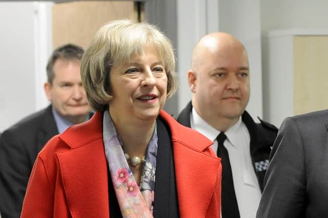 Theresa May when home secretary visited the University in Portsmouth and met Chief Specials Officer Tom Haye, pictured right next to Mrs May. Picture: Sarah Standing (160101-1003)