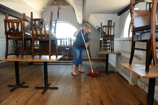 Penny Thornhill cleans the floor at the Inn on the Beach, Hayling Island. Picture: Sarah Standing (230620-467)