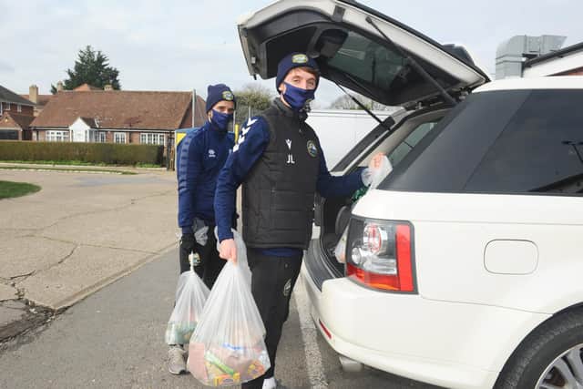 Gosport Borough FC players Pat Suraci and Joe Lea loading 'Feed a Family' parcels into cars for deliveries. Picture: Sarah Standing