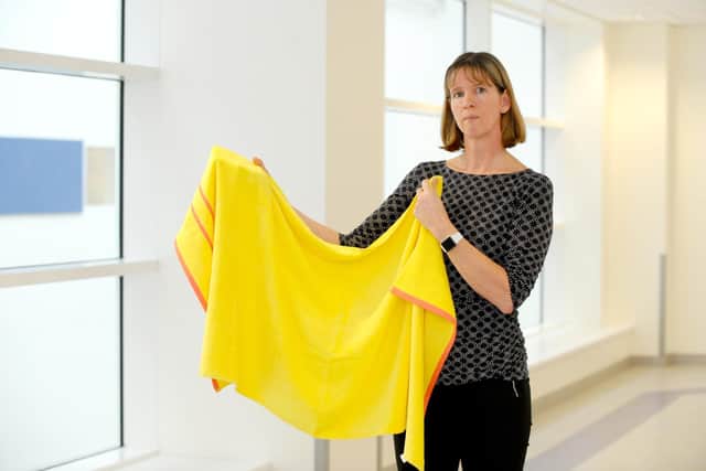 Inspector Louise Tester pictured with a yellow towel similar to the one officers recovered from close to the scene, believed to have been used to wrap up the infant. Picture: Sarah Standing (300120-5171)