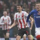 Sunderland defender Tom Flanagan watches Pompey's Ronan Curtis go past him during Saturday's game at Fratton Park.  Picture: Jason Brown