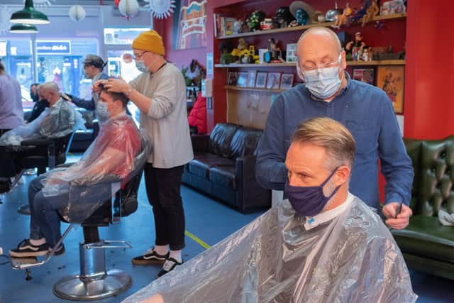 Head hairdresser Rick Christie and client Simon Potter. Rick has found the second lockdown 'very isolating'. 

Picture: Keith Woodland