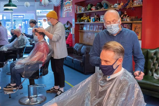 Head hairdresser Rick Christie and client Simon Potter. Rick has found the second lockdown 'very isolating'.
Picture: Keith Woodland
