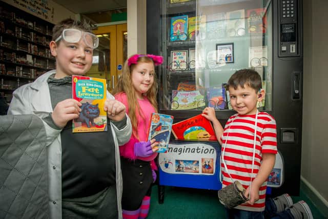 Georgie Palmer, 10, Bethany Strutt, 9, and Zachary Howard, 6, were the first three students to purchase books after being nominated for a special gold coin.
Picture: Habibur Rahman