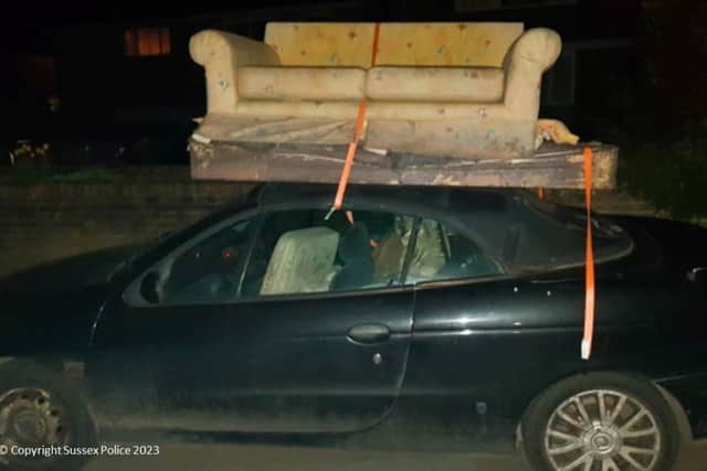 Matthew Dummer, 34, of Stedham, West Sussex, received a driving ban at Portsmouth Crown Court after loading a sofa and a mattress on top of his soft-top Renault coupe. Picture: Sussex Police.