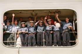 Members of the ship's company of HMS Invincible wave to their families as the ship comes alongside in Portsmouth in 1999. Picture: Pete Langdown. The News 992543-2.