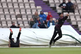 Tom Lammonby, left, has just knocked the ball back into play for Somerset team mate Will Smeed to take the catch to dismiss Brad Wheal. Photo by Warren Little/Getty Images