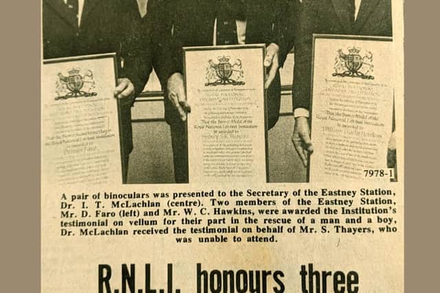 RNLI crew issued testimonial vellums after rescuing a father and son from a motor cruiser. Pictured from L to R - Dennis Faro, Dr I. T. McLachlan, and William Hawkins. Sid Thayers, part of the crew, was unable to attend. Newspaper clipping from The News. Picture: RNLI.