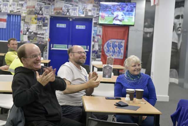 England fans come to the Legends Lounge at Portsmouth FC on Monday, November 21 to watch the England v Iran World Cup match. Pictured is: (l-r) Stephen Johnson (41) from Copnor, Stephen Jerome (46) with his mum Jean Jerome (72) both from Fratton.Picture: Sarah Standing (211122-6843)
