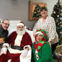 The Rotary Club Fareham celebrate Christmas by giving all children the chance to meet Santa at Coco’s Coffee Shop. 
Pictured: Coco’s coffee shop in Miller Drive Fareham with customer Kevin Wickham, Santa, Rotarian and coffee shop owner Jackie Avis standing and elf Belle Johnson kneeling.