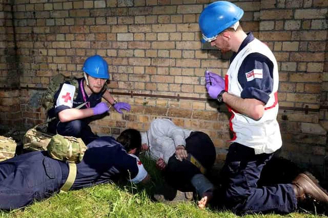 Pictured: Medics and first aiders help a casualty during a disaster relief exercise. Credit: LPhot Dan Rosenbaum RNAS Yeovilton