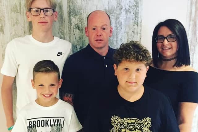 Loving dad Andrew Blomfield, centre, has been left with a fractured skull. He is pictured with his family. Left to right: sons Callum, Dexter and Beau with mum Laura.