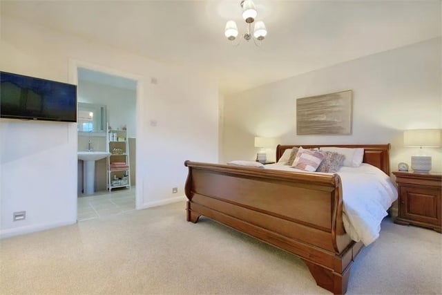 The master bedroom has an extensive range of built-in wardrobes with mirror fronted doors and a door to the en-suite.