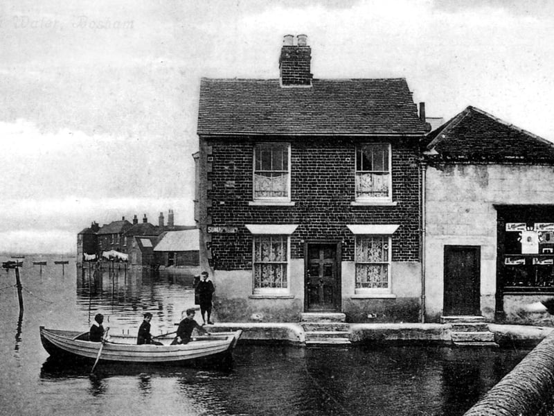 Bosham High water.
Village lads about 100 years ago rowing in high water at Bosham Lane