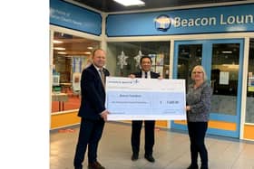 Caption: Emlyn Taylor, Alan Mak MP and Liz Ascua present £1,400 cheque to Beacon Food Bank Credit: Lockheed Martin UK