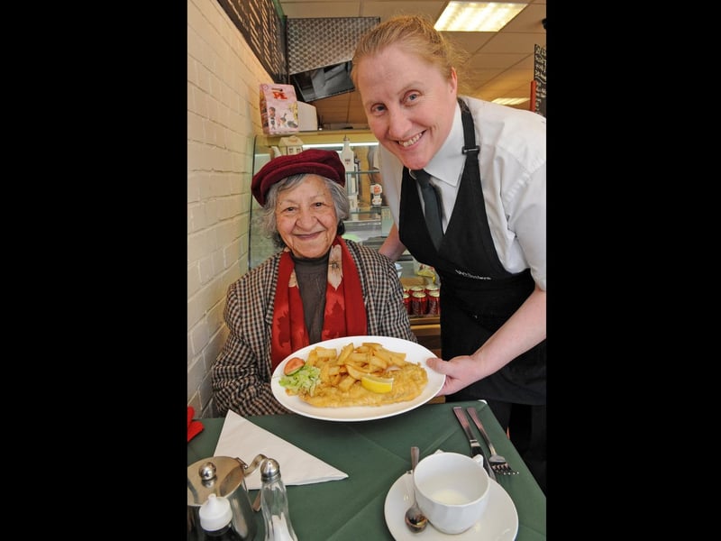 2011. Whistlers Fish and Chip shop in West Fareham. (left to right) Mrs Francesina Henderson (80) is served her regular cod and chips by Sandra Bishop (42) . Picture: Malcolm Wells 110911-5619