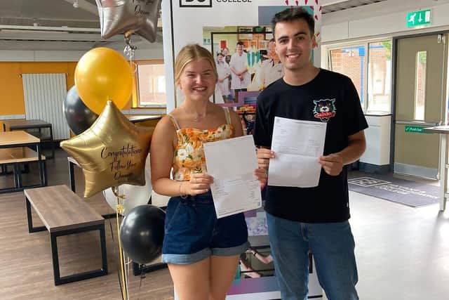 Lydia Adie and Ross McGregor collecting their results from Havant and South Downs College