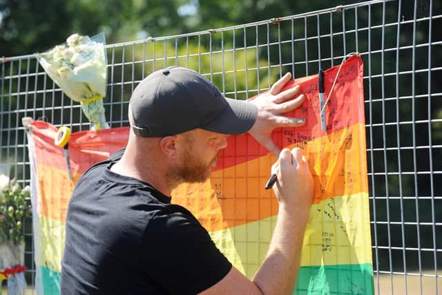 Tributes left in Fareham Park Recreation Ground just off Hilson Drive in Fareham, where a man died after allegedly being attacked by a dog.

Pictured is: Ben Durham from Fareham, leaves a tribute.

Picture: Sarah Standing (120822-8745)