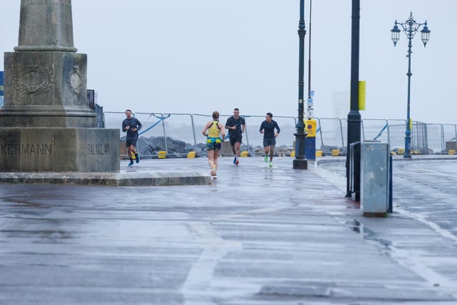 Runners hit the streets in wet and windy conditions despite The Great South Run being cancelled.