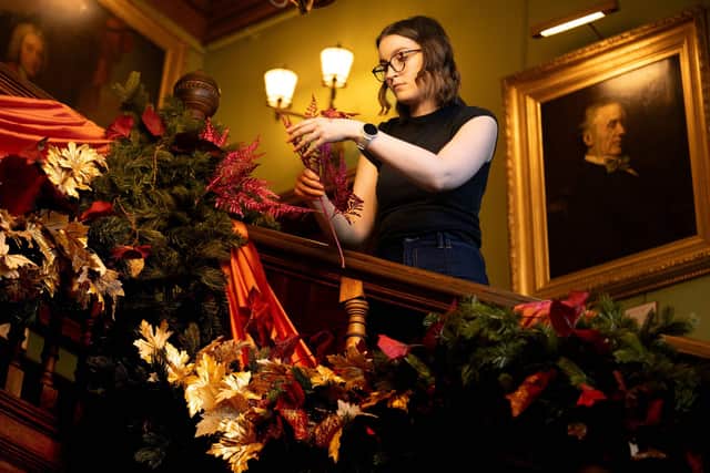 Putting finishing touches to the grand staircase for A Palace House Christmas