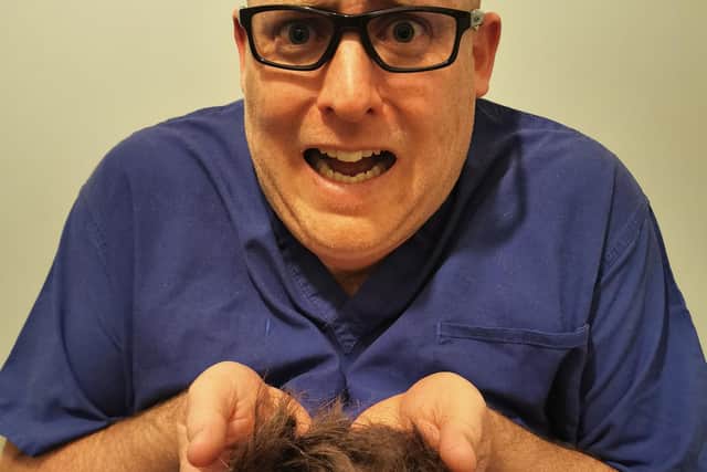 Lee George holding his removed hair after the head shave. He has so for raised over £3,000 for Queen Alexandra Hospital.